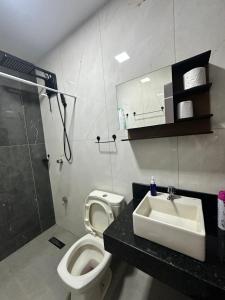 a bathroom with a toilet and a sink and a shower at Casa independiente en Ciudad del Este in Ciudad del Este +17 photos