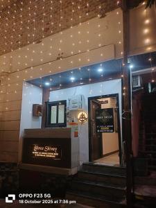 a store entrance with a sign on the wall and stairs at Hotel Shree shivay omkareshwar in Godarpura +30 photos