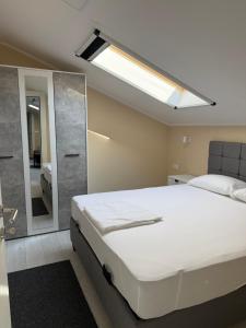 a bedroom with a large bed and a mirror at Vivko apartmani 2 in Ostrovo +38 photos