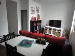 a living room with a red couch and a table at Historic Downtown II in Vila Real +4 photos