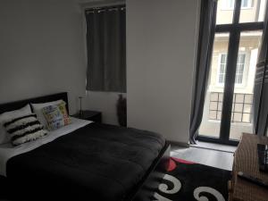 a bedroom with a bed and a large window at Historic Downtown II in Vila Real