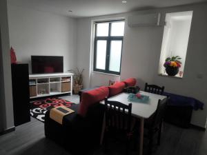 a living room with a table and a couch at Historic Downtown II in Vila Real