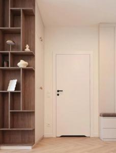 a white door in a room with shelves at GW Apart in Gorzów Wielkopolski