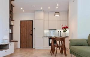 a kitchen and living room with a table and a couch at GW Apart in Gorzów Wielkopolski +1 photo