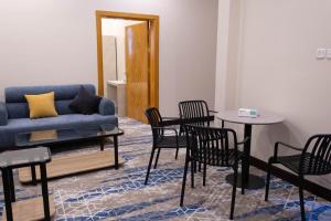 a living room with a couch and a table and chairs at مـهادا Mehada in Taif