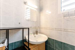 a bathroom with a sink and a mirror at Au Franciscea, climatiseurs, centre ville, sud in Saint-Louis +20 photos