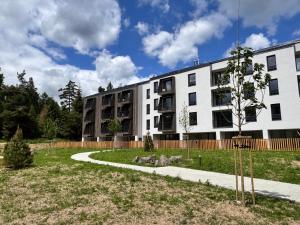 an apartment building with a park in front of it at Apartment Tatry Gerlachov, Vysoke Tatry in Svätý Jur