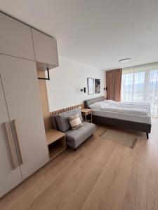 a large bedroom with a bed and a couch at Apartment Tatry Gerlachov, Vysoke Tatry in Svätý Jur