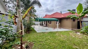 a house with a green tent in the yard at Jubilant Experience Homes Arusha in Arusha
