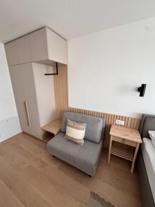 a small living room with a couch and a table at Apartment Tatry Gerlachov, Vysoke Tatry in Svätý Jur