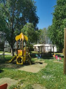 a park with a playground with a slide at Camping du Pontis in Verteillac