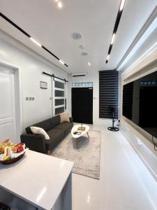 a living room with a couch and a table at One Plus One Luxe Retreat with Airport Pickups in Sakumona