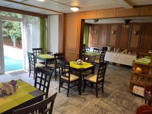 a restaurant with tables and chairs in a room at Solar Club Apartman Sopron in Sopron +51 photos
