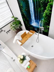 a bathroom with a waterfall painting on the wall at One Plus One Luxe Retreat with Airport Pickups in Sakumona +24 photos
