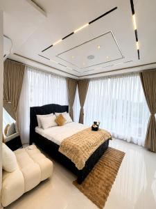a bedroom with a large bed and a couch at One Plus One Luxe Retreat with Airport Pickups in Sakumona