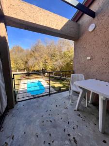 a patio with a table and a view of a pool at FlussHaus VGB in Villa General Belgrano +9 photos