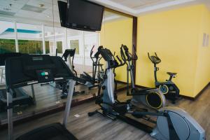 a gym with several exercise bikes and a flat screen tv at Sierra Huasteca Inn in Ciudad Valles