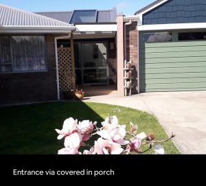 a bunch of pink flowers in front of a house at Digs Homestay in Stratford