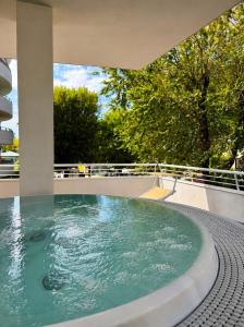 a hot tub on the roof of a house at Hotel Aragosta in Cattolica