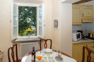 a kitchen with a table and a window at Relais Villa Sensano in Pignano