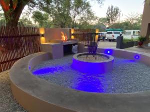 a fire pit in a yard with a fire place at Echo Mountain Inn in Thabazimbi