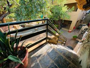 a stairway with a fence and a potted plant at Echo Mountain Inn in Thabazimbi