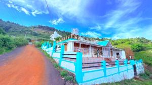 a house on the side of a dirt road at Arupa Homestay in Ooty +5 photos