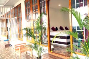 a hotel room with a bed and a mirror at Arupa Homestay in Ooty
