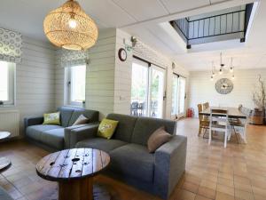 a living room with a couch and a table at Le Moulin de Rendeux in Rendeux