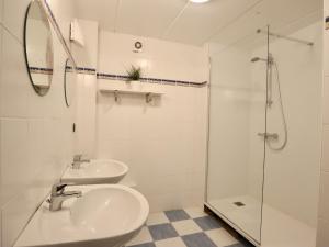 a white bathroom with two sinks and a shower at Le Moulin de Rendeux in Rendeux +30 photos