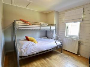 a small room with a bunk bed with white sheets at Le Moulin de Rendeux in Rendeux