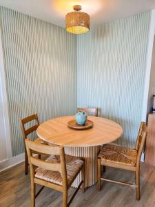 a wooden table with chairs and a bowl on top at Lavish Coastal Oceanfront Suite Yachtsman 401 in Myrtle Beach