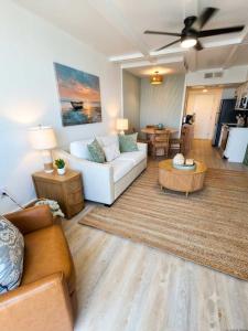 a living room with a white couch and a table at Lavish Coastal Oceanfront Suite Yachtsman 401 in Myrtle Beach