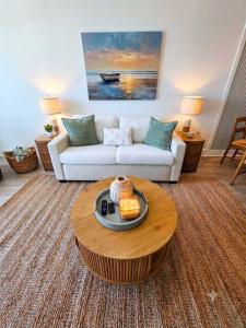 a living room with a couch and a coffee table at Lavish Coastal Oceanfront Suite Yachtsman 401 in Myrtle Beach