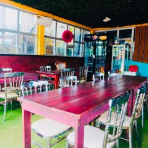 a restaurant with a pink table and chairs in a room at point de distraction in Foumban