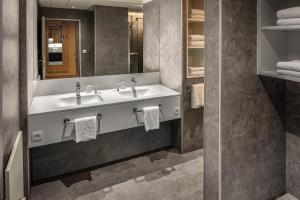 a bathroom with two sinks and a mirror at Floreal Blankenberge in Blankenberge +26 photos