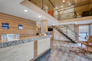 a lobby with a bar with a staircase in the background at Best Western Plains Motel in Wall