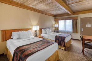 a hotel room with two beds and a desk at Best Western Plains Motel in Wall +42 photos