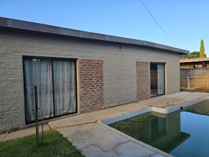 a house with a swimming pool in front of it at Cooperville 1 in Potchefstroom