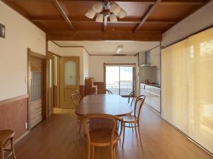 a dining room with a wooden table and chairs at Hourokusha - Vacation STAY 13417 in Doji