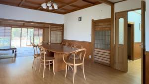 a dining room with a wooden table and chairs at Hourokusha - Vacation STAY 13417 in Doji
