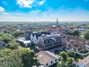 an aerial view of a town with buildings and a church at Hotel The Dunes in Domburg