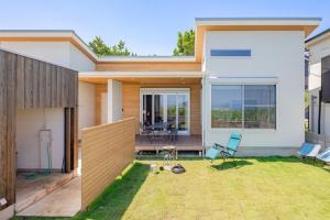 a house with a lawn in front of it at The Wave - Vacation STAY 62368v in Hokota