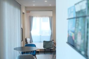 a room with a table and chairs and a window at The Wave - Vacation STAY 62368v in Hokota +6 photos