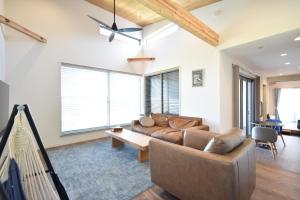 a living room with a couch and a table at The Wave - Vacation STAY 62368v in Hokota
