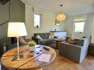 a living room with a table and a couch at Le Moulin de Rendeux in Rendeux