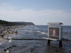 a billboard on the beach with people in the water at Forum Marinar 38 in Bansin +33 photos