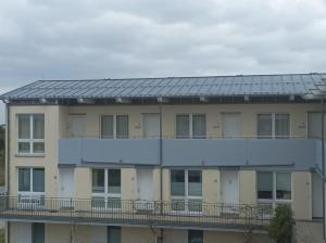 a building with a solar roof on top of it at Forum Marinar 38 in Bansin