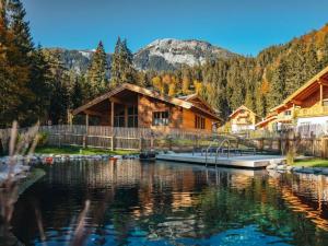 a log cabin with a lake in front of it at Chalet Jona in Sonnberg