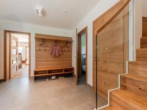 a bathroom with wooden walls and a staircase in a house at Chalet Jona in Sonnberg